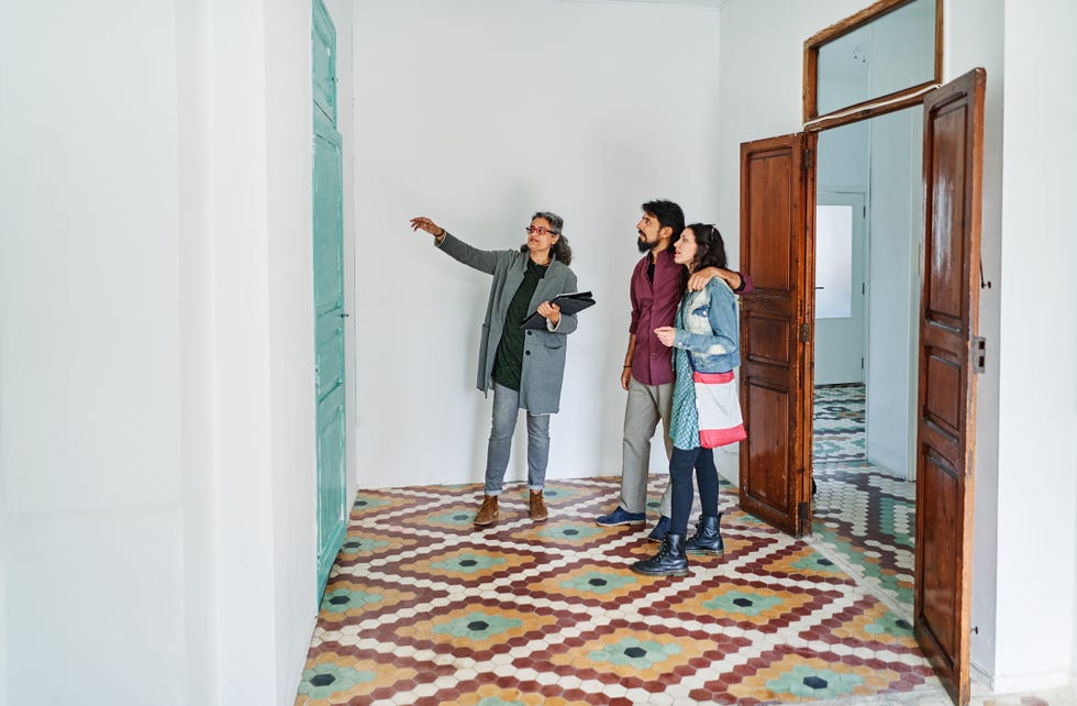 diverse couple and real estate agent examining rental options