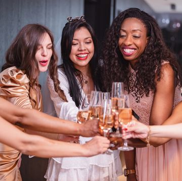 a group of female friends toasting to the bride to be