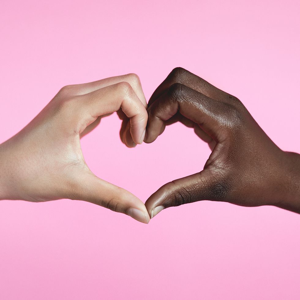 diverse hands with love sign