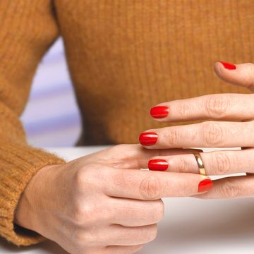 divorced woman taking off wedding ring