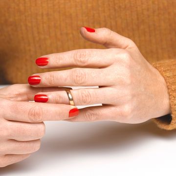 divorced woman taking off wedding ring