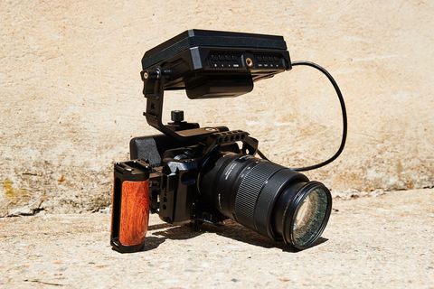 canon camera with handle battery pack and on camera monitor