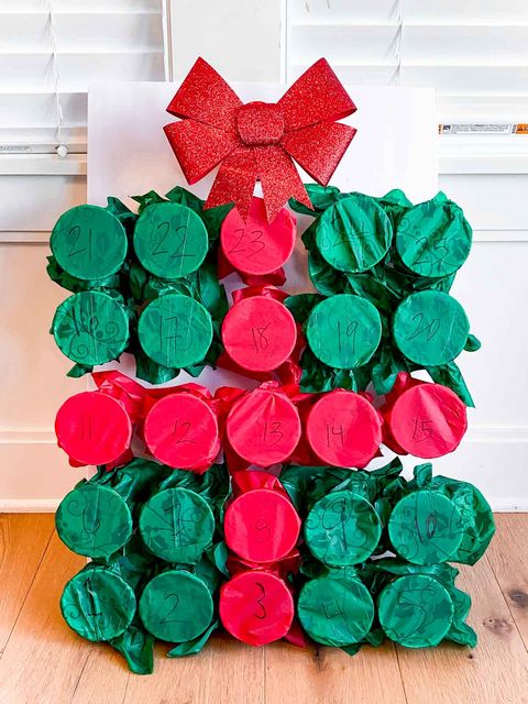 advent calendar made with plastic cups and green and red tissue paper