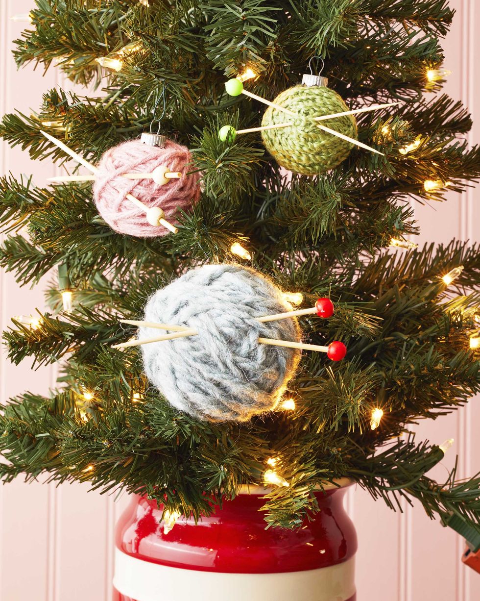 yarn ball ornaments with cocktail pick knitting needles on a mini christmas tree