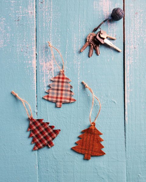 three tree shaped diy air fresheners covered with plaid fabric made for christmas gifts