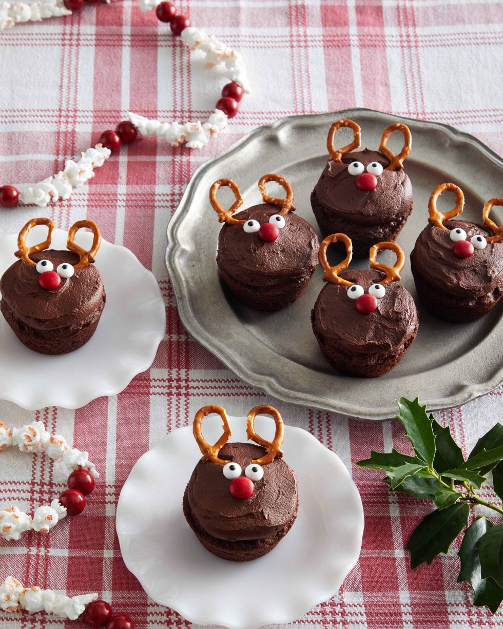 Chocolate brownie decorated with candy frosting and tiny pretzel horns so everything looks like a reindeer