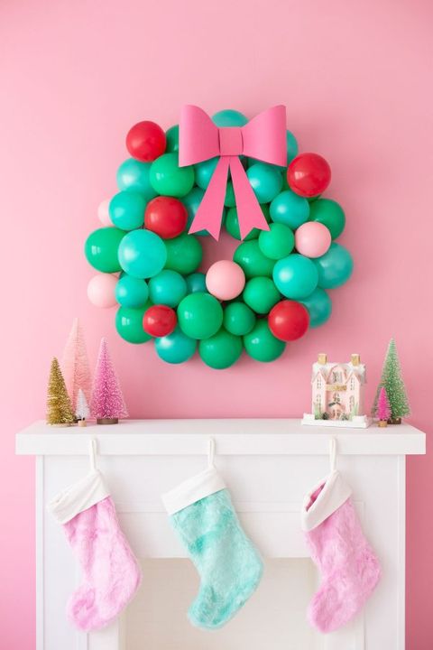 diy christmas wreaths, colorful wreath made of balloons hanging above a mantel