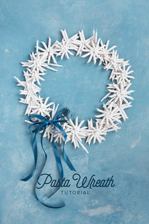 diy christmas wreaths, white wreath made of pasta against blue background