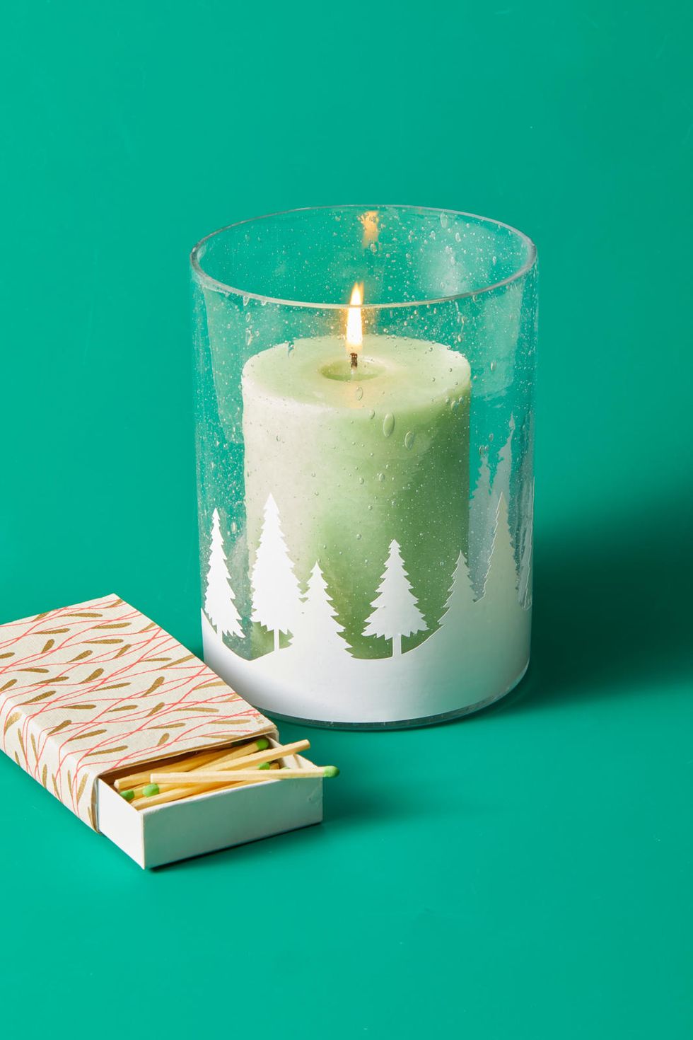diy christmas gifts christmas cutout candle with a white design on the front and matches beside it