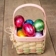 a small wicker easter basket with foil eggs