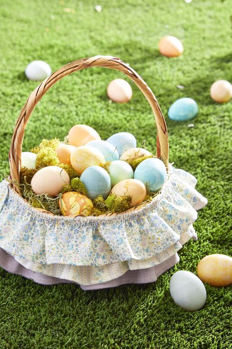 easter basket with threetired skirt on grass filled with eggs