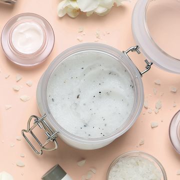 flat lay composition with body scrubs on pink background
