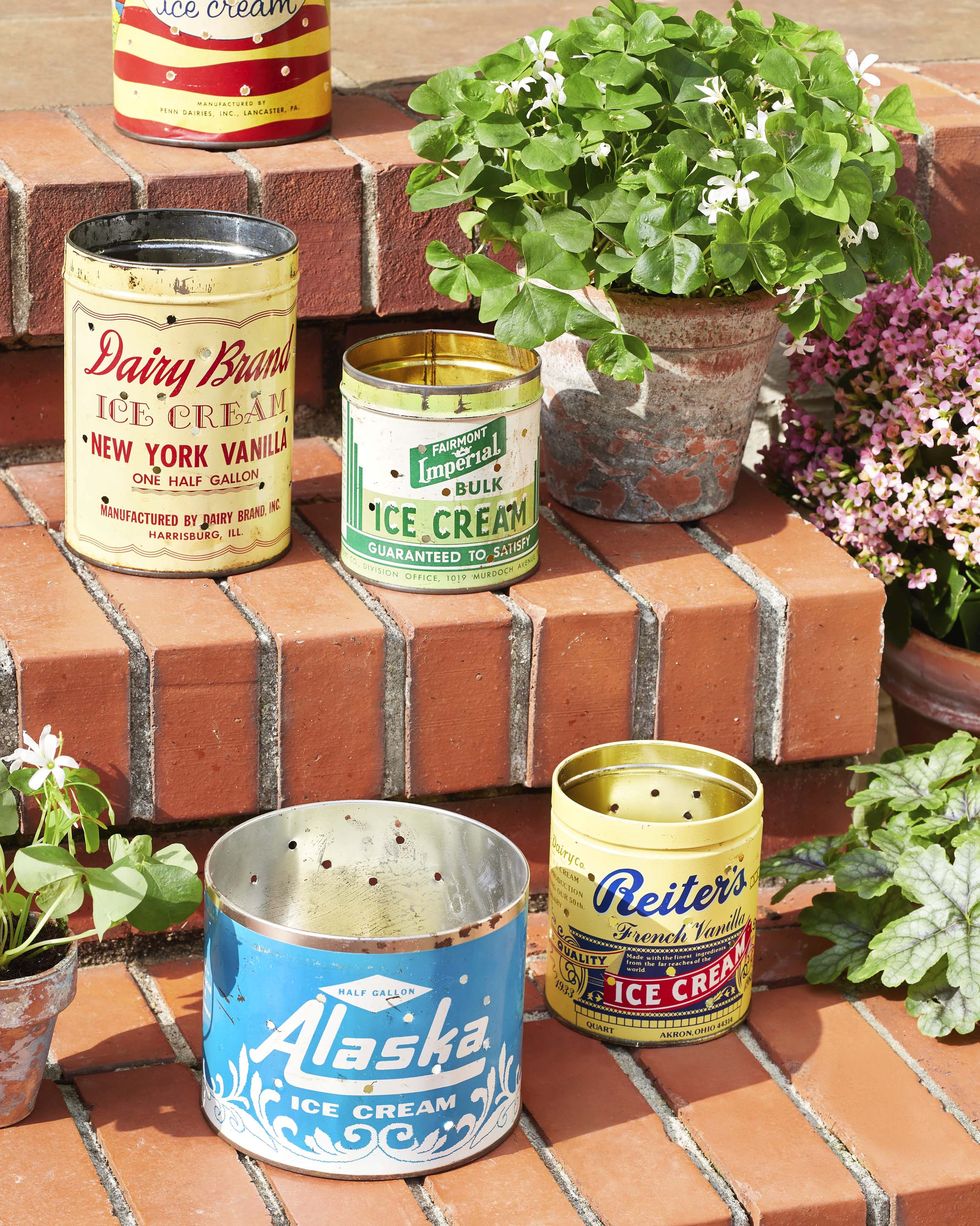 vintage metal ice cream tins with holes drilled in them so they are turned into luminaries