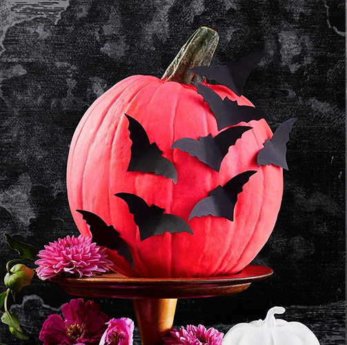 diy halloween decorations, pink pumpkin with bat designs and a tombstone chair cover