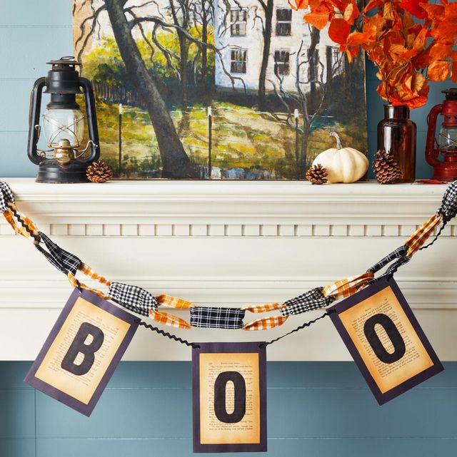 boo garland made from vintage book pages hung on a mantel
