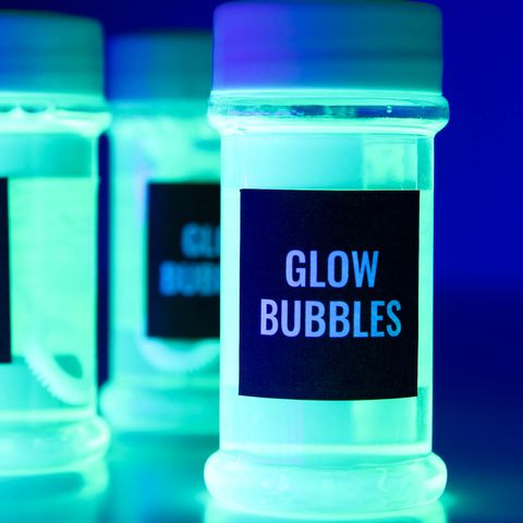 a set of bubble bottles glow under a blacklight the project is a good housekeeping pick for best activities for kids
