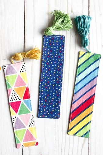 a set of fun patterned bookmarks against a wood background