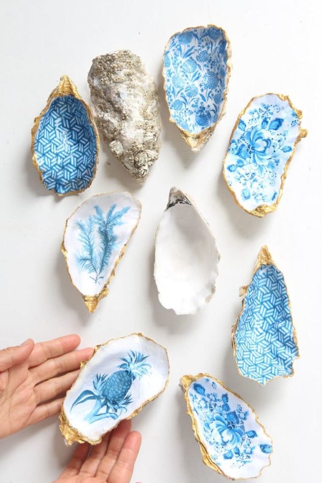 a selection of blue patterned trinket dishes made from oyster shells