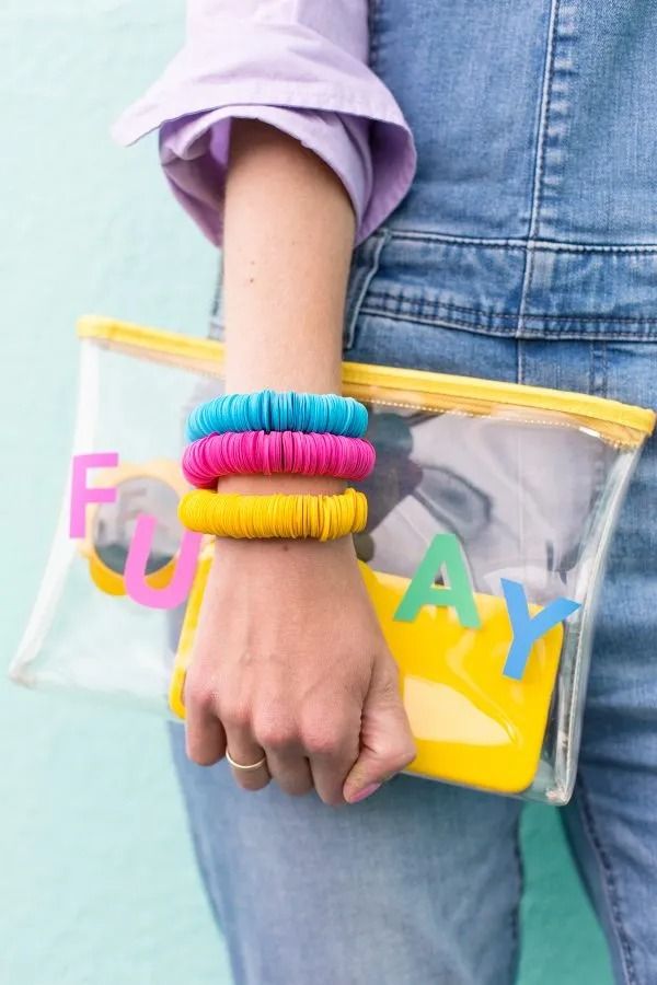 DIY Mother's Day Gift, Paper Disc Bracelet on the Arm of a Woman Holding a Clutch