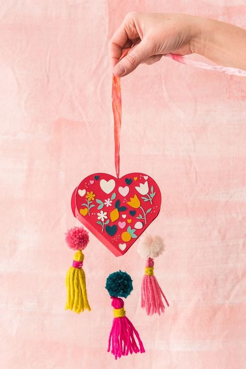 diy mothers day gifts, hand holding a pom pom heart box