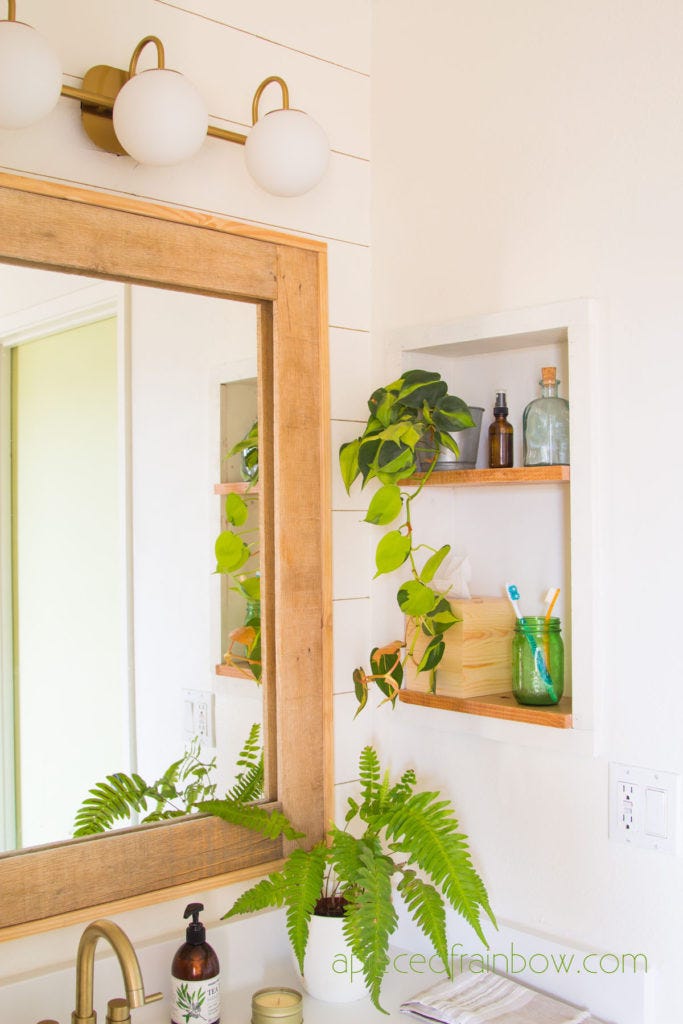 bathroom mirror with natural elements and shelves