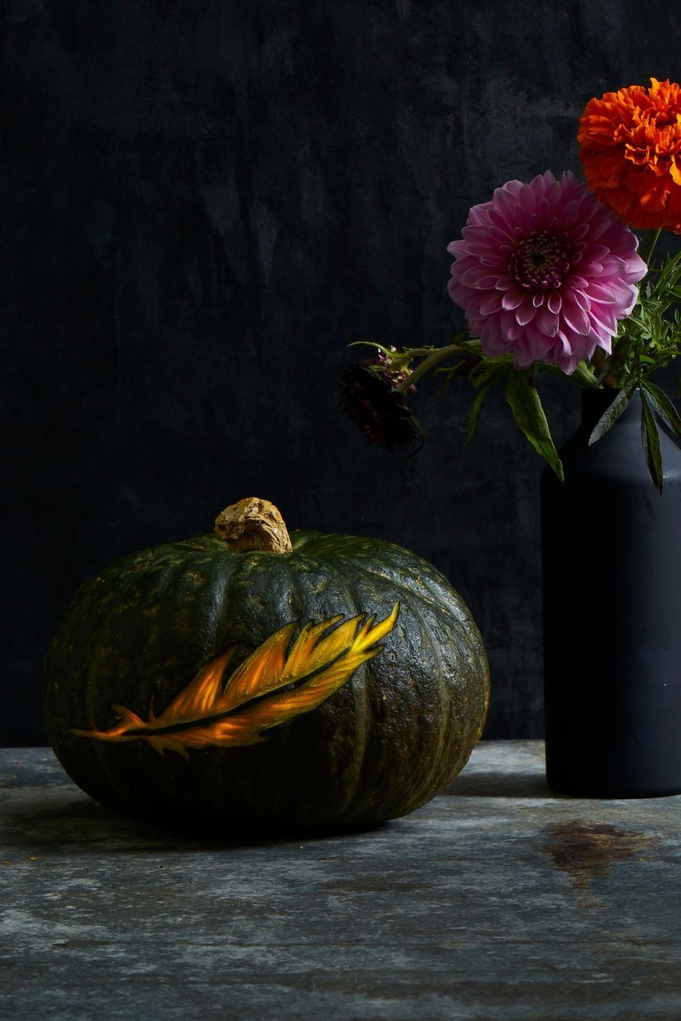 diy outdoor halloween decorations feather carved into a black pumpkin
