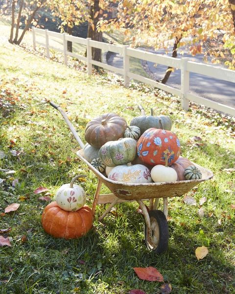 wheelbarrow full of decorated pumpkins