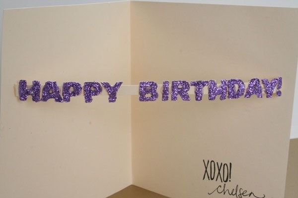 diy popup card with purple glitter letters spelling out happy birthday