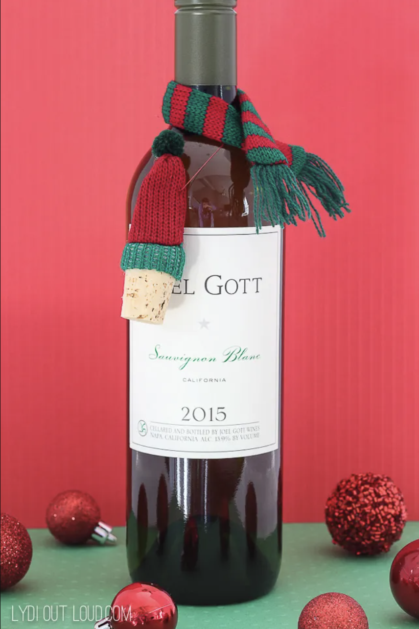 diy christmas gifts wine bottle with a mini scarf around the stem