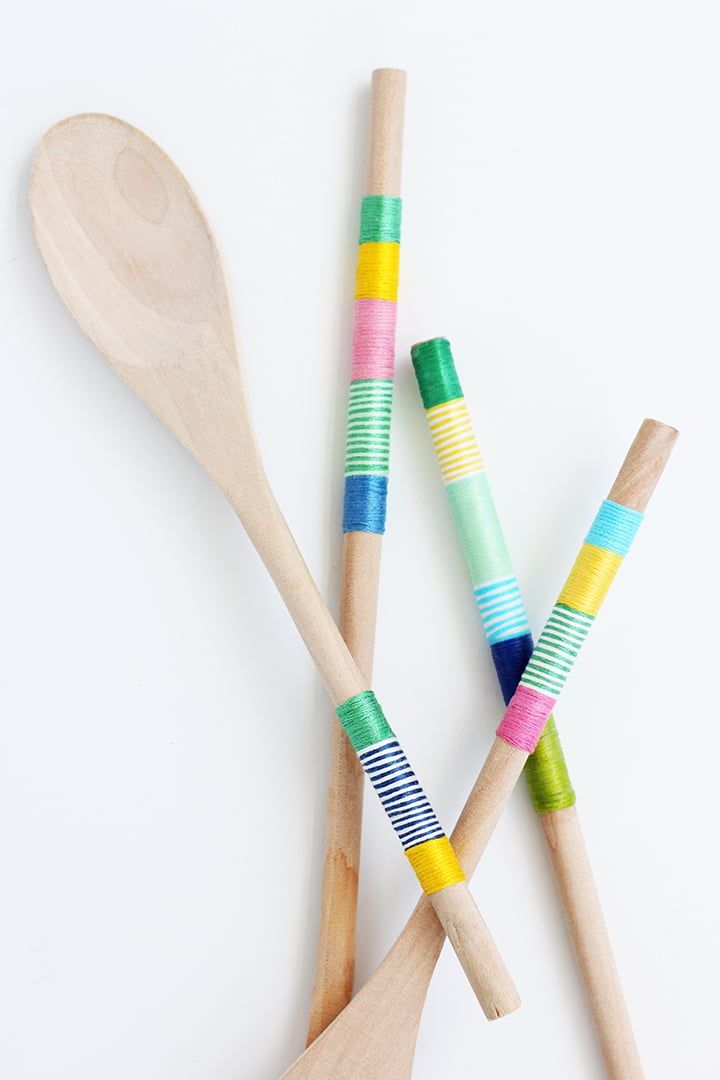diy christmas gifts, wrapped wooden spoons in colorful embroidery thread