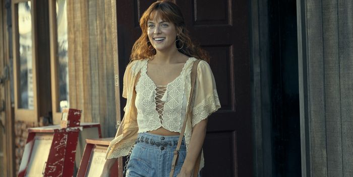 riley keough as daisy wears a lace crop top and high rise jeans from daisy jones and the six