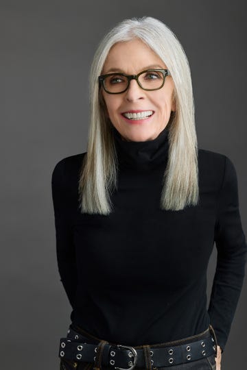 a woman with glasses smiling