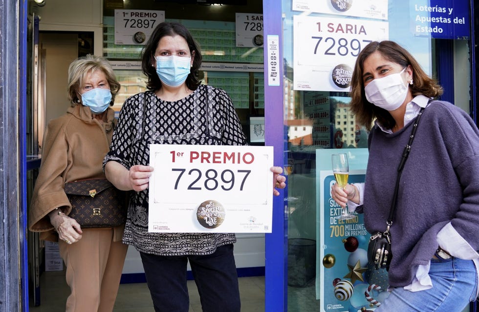 lottery shop owner monica cejudo holds up a first prize winning ticket of spain's christmas lottery el gordo the fat one in bilbao, december 22, 2020  local caption