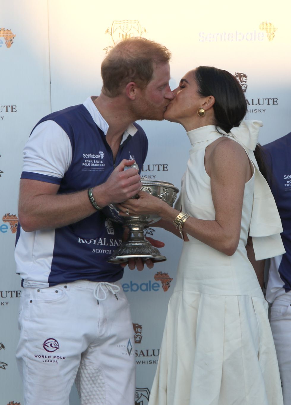 the duchess of sussex presents the trophy to her husband, the duke of sussex after his team the royal salute sentebale team defeated the grand champions team, in the royal salute polo challenge, to benefit sentebale, at the uspa national polo center in wellington, florida, us picture date friday april 12, 2024