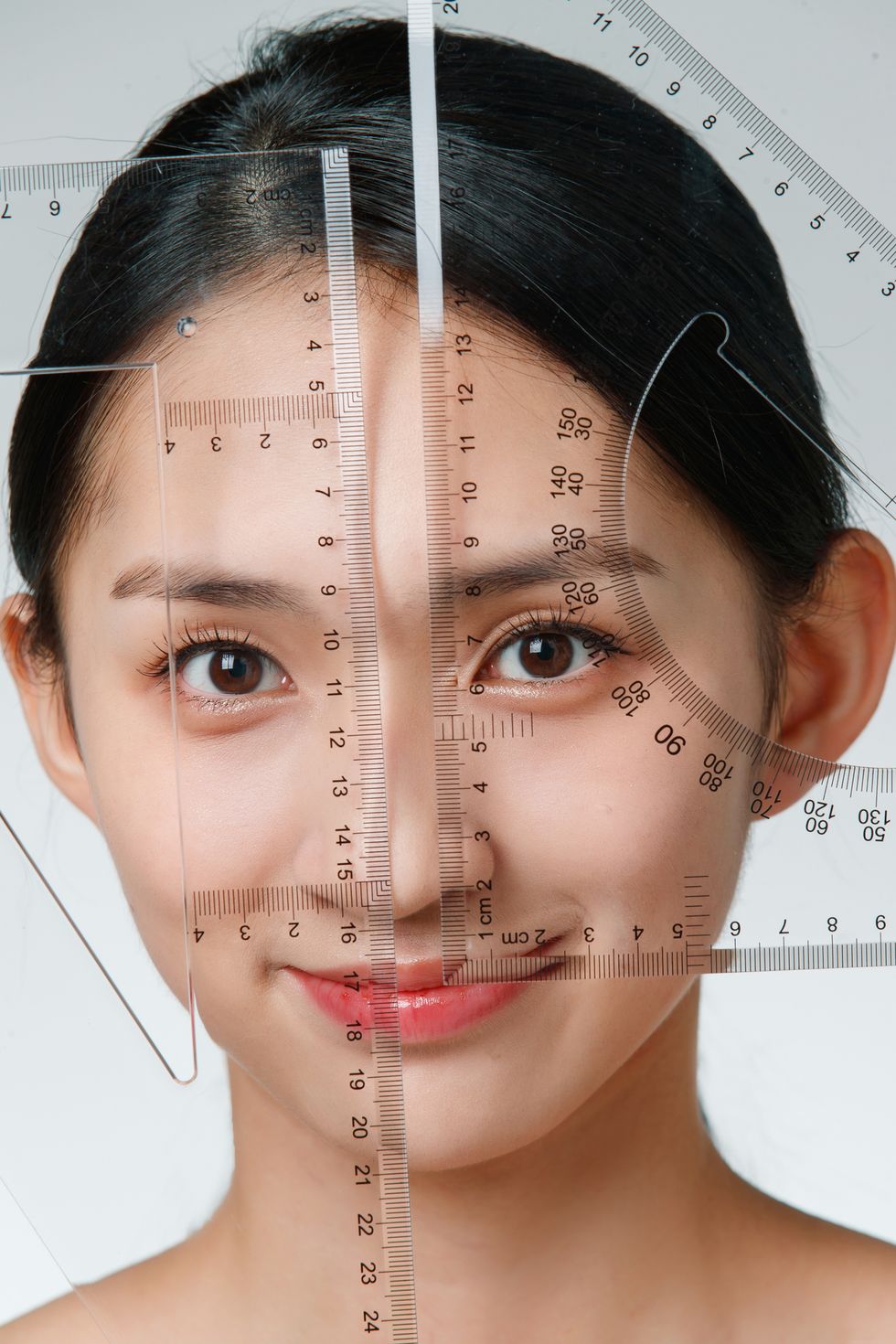 do facial plastic young woman with a ruler