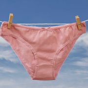 vaginal itching reasons, new pink cotton panties on clothesline with clothespins and orchid flower in blue sky background woman underwear