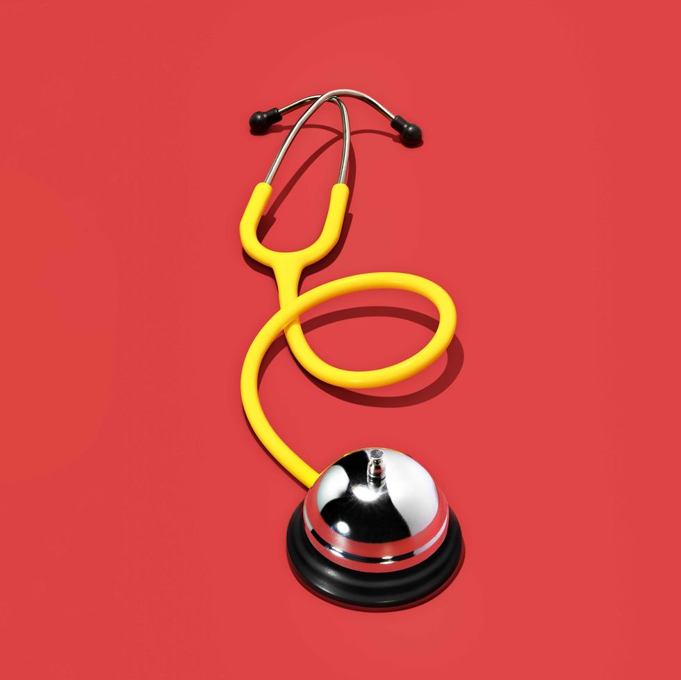 yellow stethoscope on red background