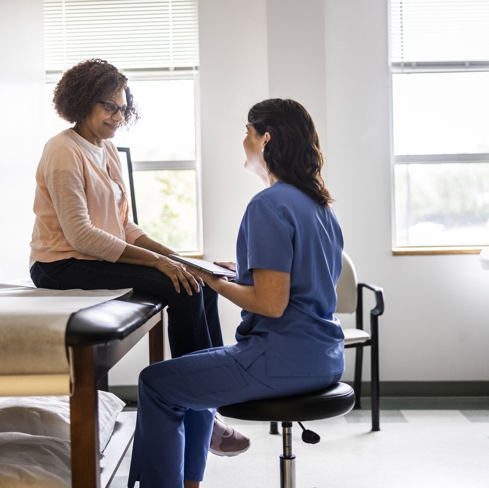 doctor and senior woman discussing treatment in doctors office
