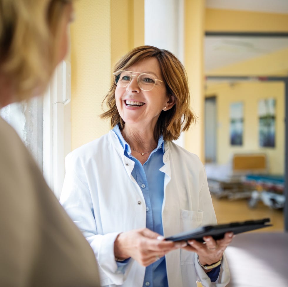 doctor discussing with woman at nursing home