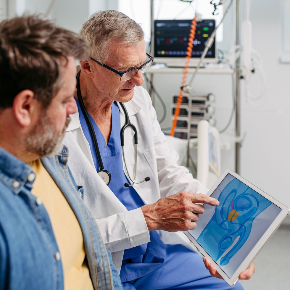 doctor explaining prostate examination to male patient.