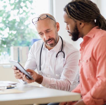 doctor giving consultation to patient using digital tablet