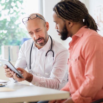 Doctor giving consultation to patient using digital tablet doctor giving consultation to patient using digital tablet