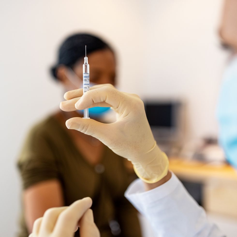 doctor preparing flu or coronavirus injection