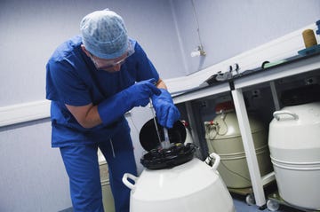 doctor removing embryo samples from cryogenic storage