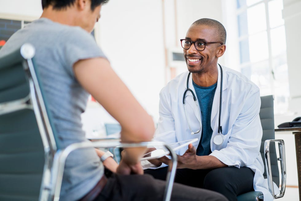 doctor showing results to patient in hospital