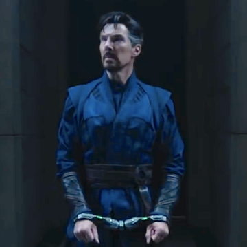 doctor strange in the multiverse of madness, a man walks through a corridor handcuffed wearing a blue robe