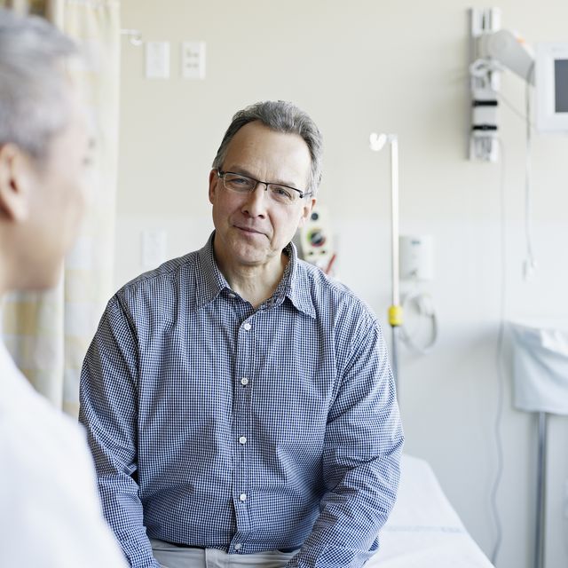 doctor talking to patient in hospital room
