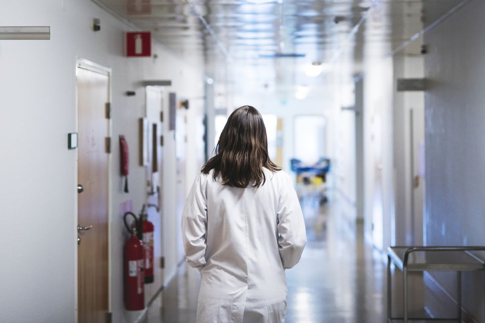 doctor walking through hospital corridor