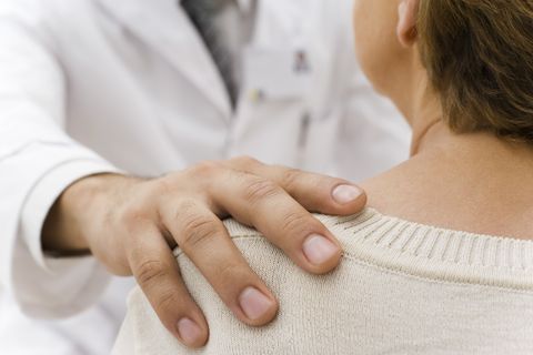 doctor's hand on patient's shoulder
