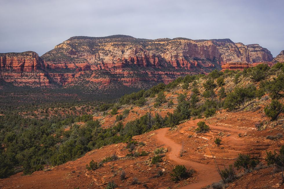 scenic view of chuck wagon trail with secret mountain and various red rock formations in the distance, sedona, arizona